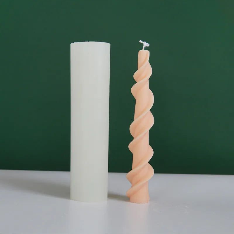 Handmade silicone candle mould with a spiral lace design for decorative wax candles.