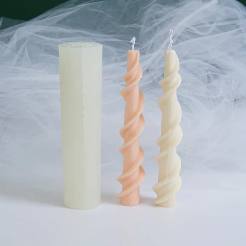 Handmade silicone candle mould with a spiral lace design for decorative wax candles.