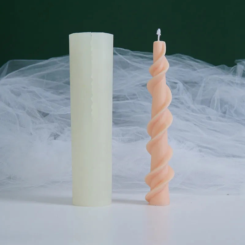 Handmade silicone candle mould with a spiral lace design for decorative wax candles.