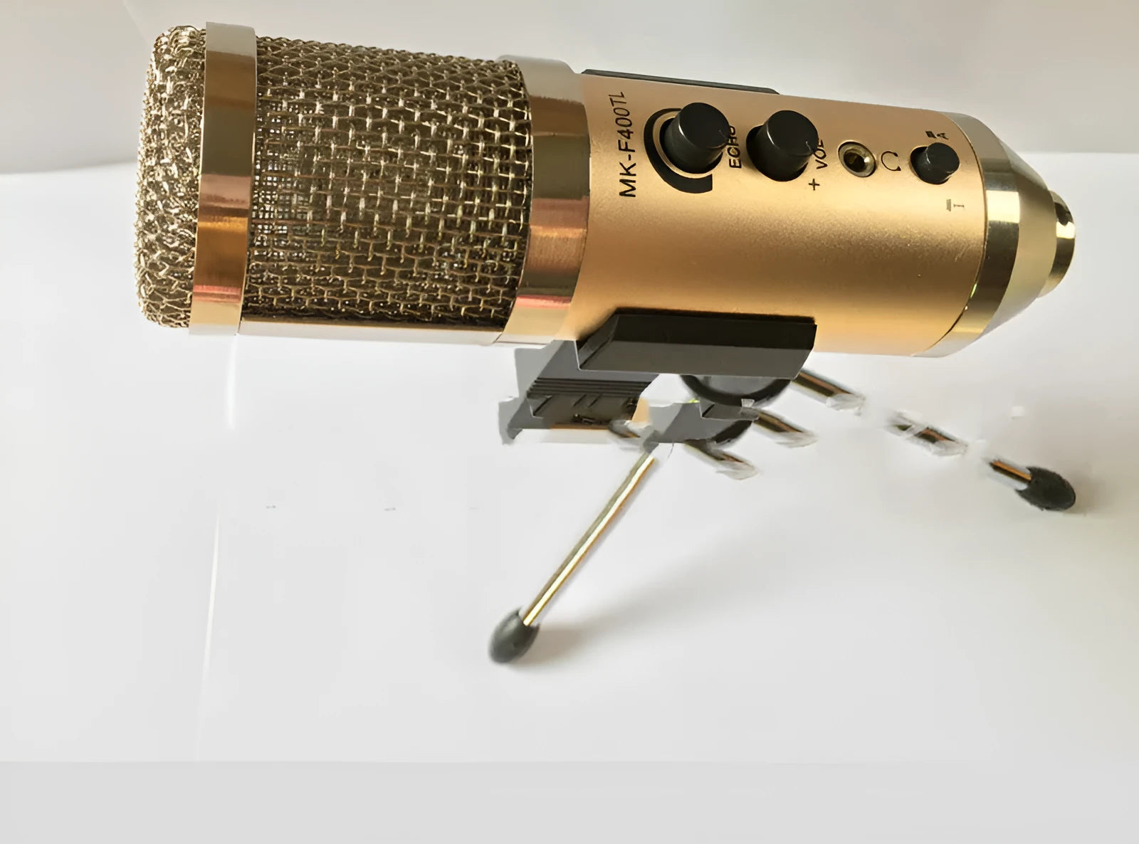 Gold USB condenser microphone with heart-shaped pickup pattern and integrated stand.