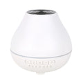 White round Bluetooth humidifier aroma diffuser with LED night light on wooden surface