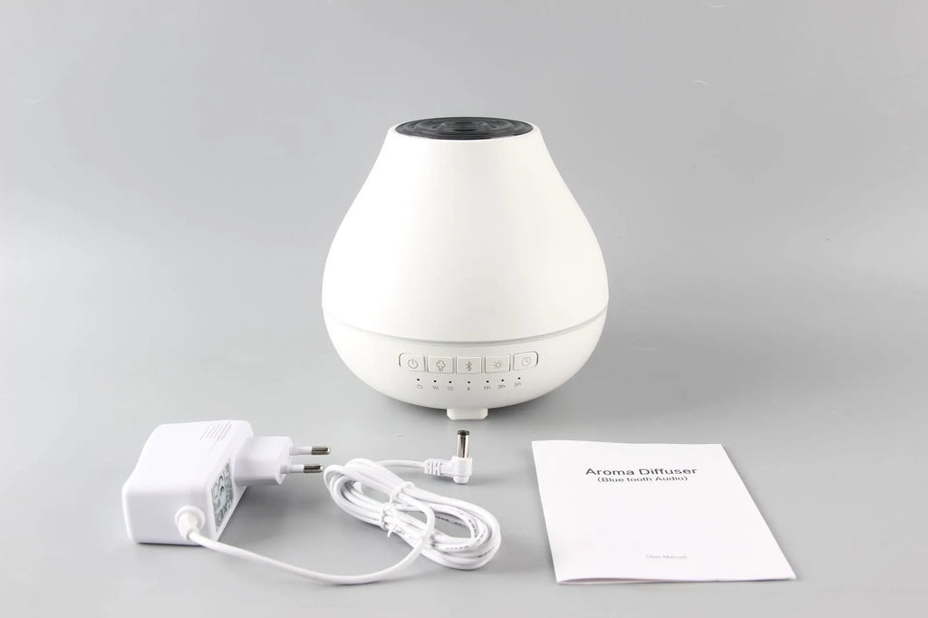 White round Bluetooth humidifier aroma diffuser with LED night light on wooden surface