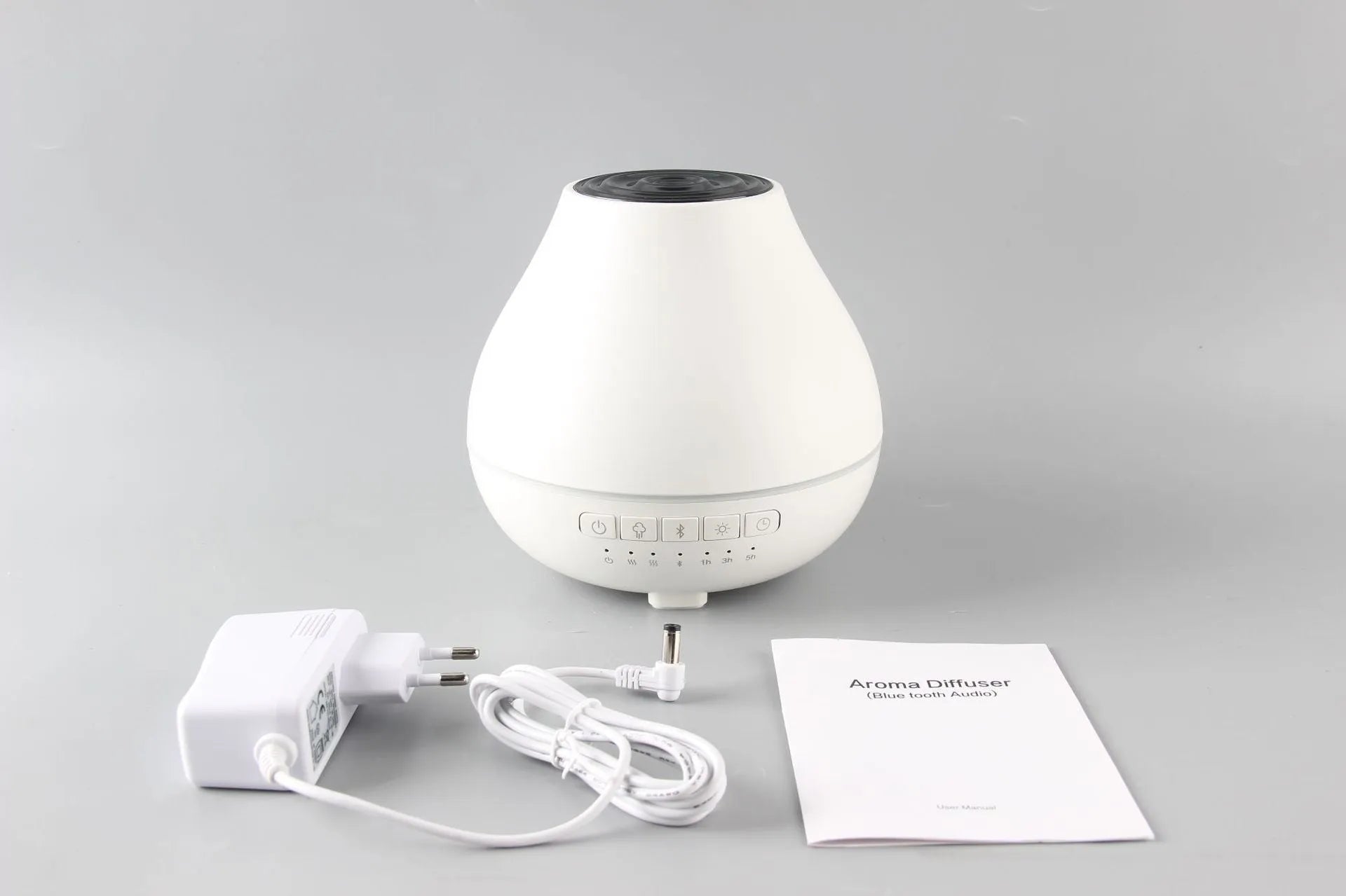 White round Bluetooth humidifier aroma diffuser with LED night light on wooden surface
