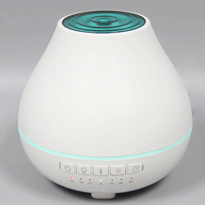White round Bluetooth humidifier aroma diffuser with LED night light on wooden surface
