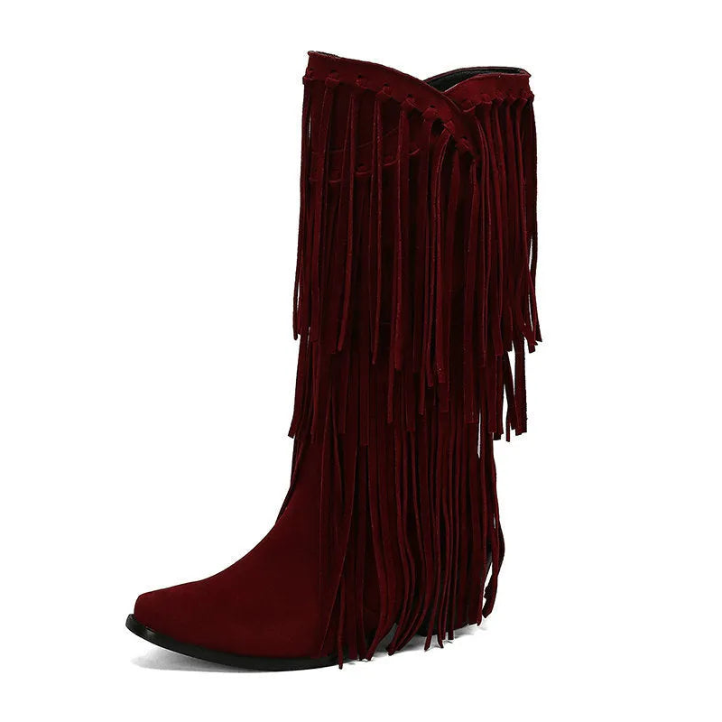 Women's beige suede mid-calf boots with a chunky heel and tassel detail on display.
