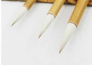 Set of three pure woolen hair Chinese calligraphy brushes with bamboo handles in large, medium and small sizes.