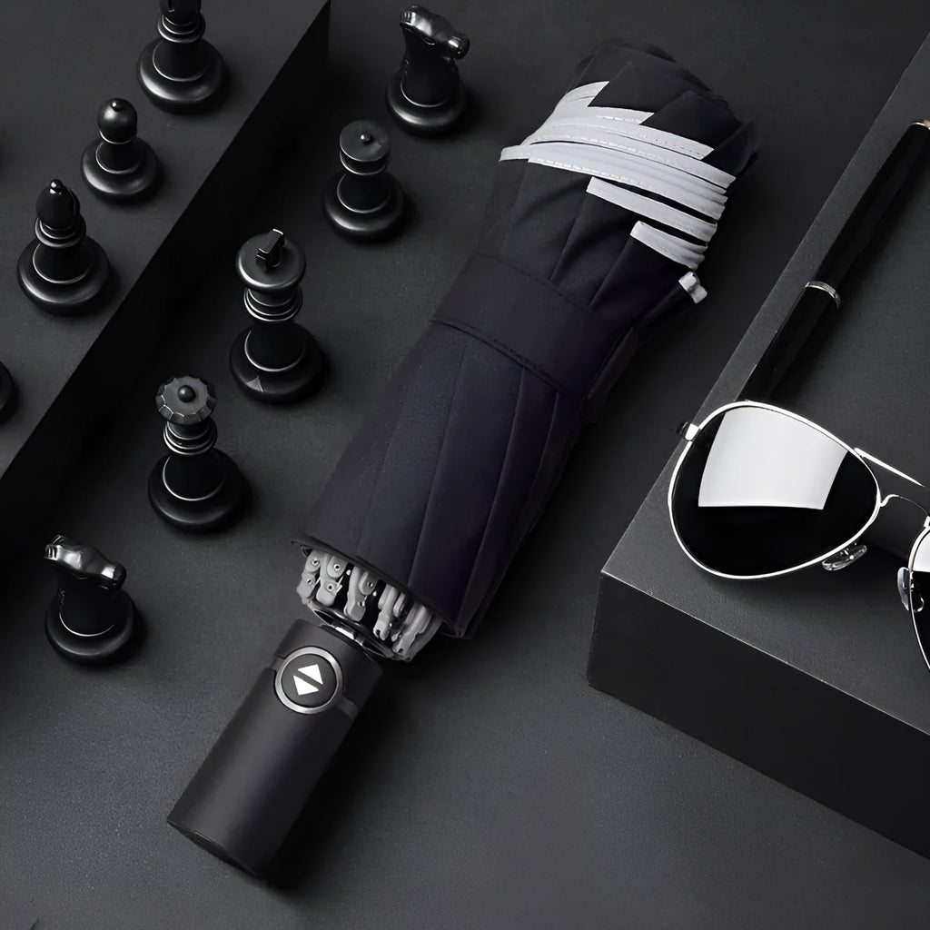 Black automatic reverse umbrella with folded canopy and non-slip plastic handle.