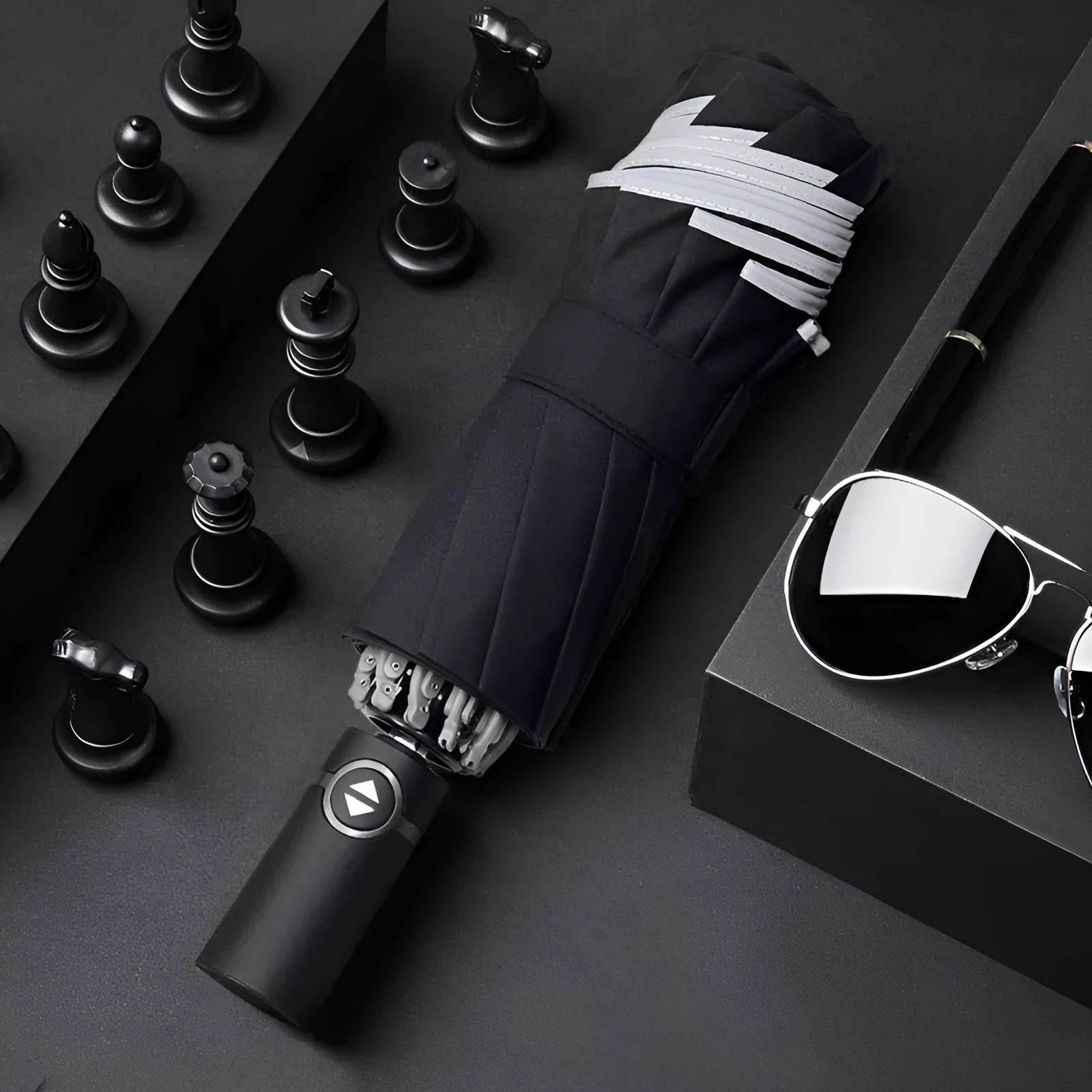 Black automatic reverse umbrella with folded canopy and non-slip plastic handle.