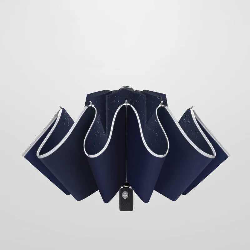 Black automatic reverse umbrella with folded canopy and non-slip plastic handle.