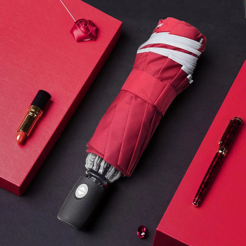 Black automatic reverse umbrella with folded canopy and non-slip plastic handle.