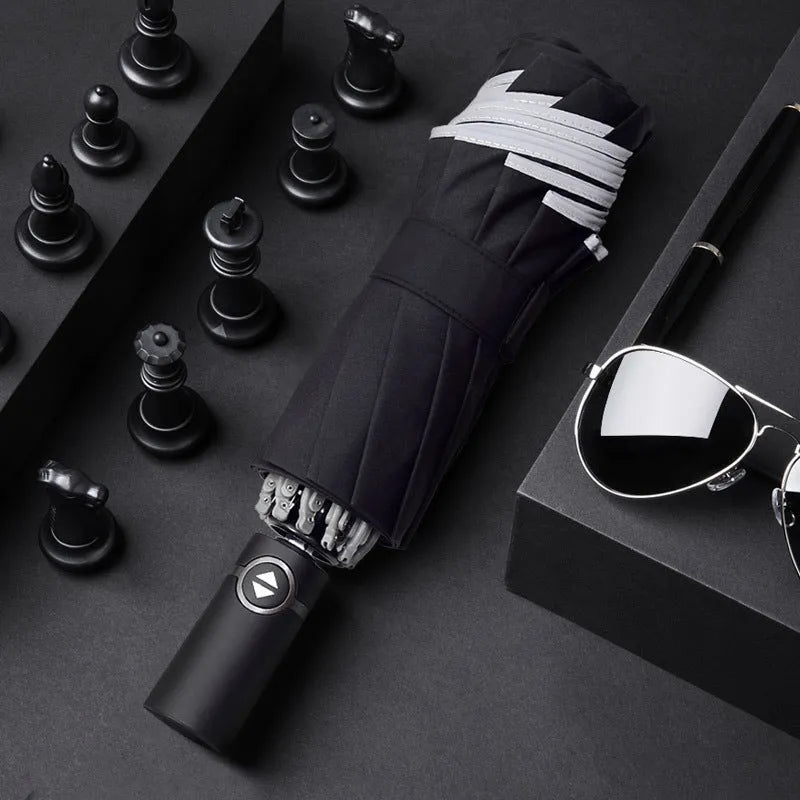 Black automatic reverse umbrella with folded canopy and non-slip plastic handle.