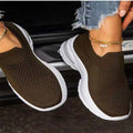 Women's white mesh sock-style sneakers with rubber sole on a plain background
