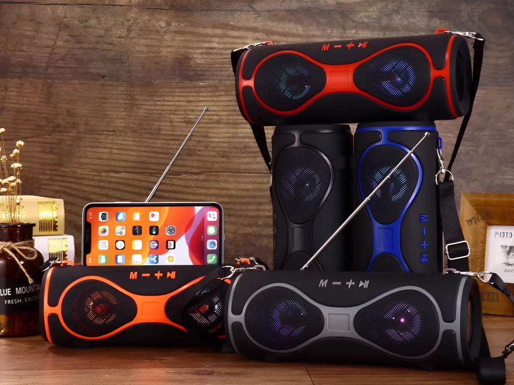 Portable Bluetooth speaker with strap and phone stand in five colour options.