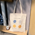 Women's canvas tote shopper bag with geometric pattern in orange and light pink options showing zip opening and shoulder straps