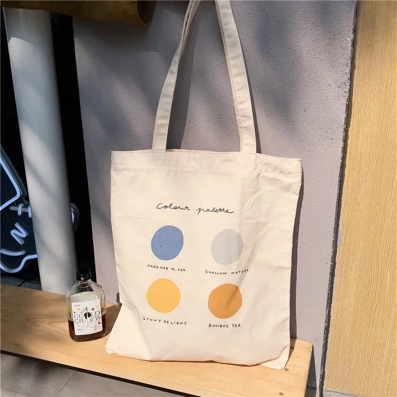 Women's canvas tote shopper bag with geometric pattern in orange and light pink options showing zip opening and shoulder straps