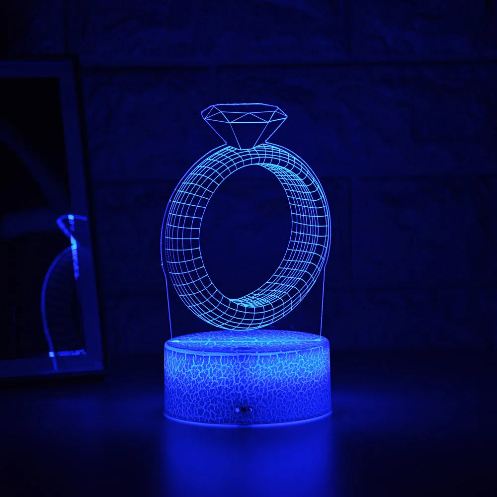3D diamond ring LED night light with colour-changing modes on black background