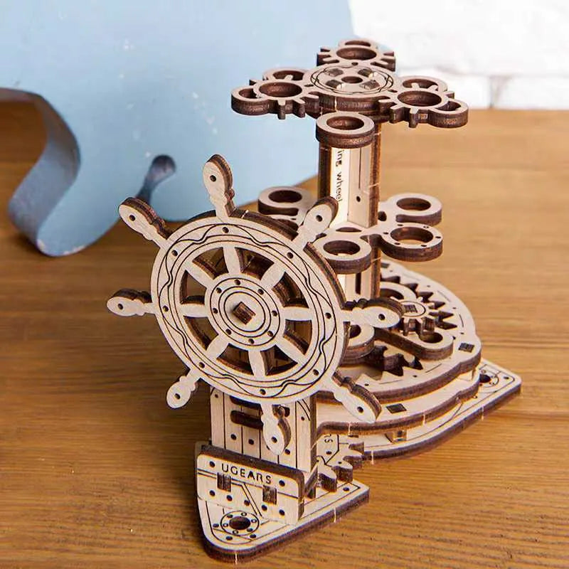 Ukrainian wooden rotating pen holder with steering wheel on a desk.