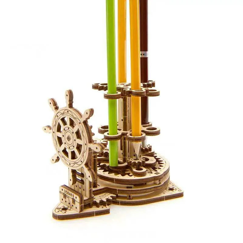 Ukrainian wooden rotating pen holder with steering wheel on a desk.