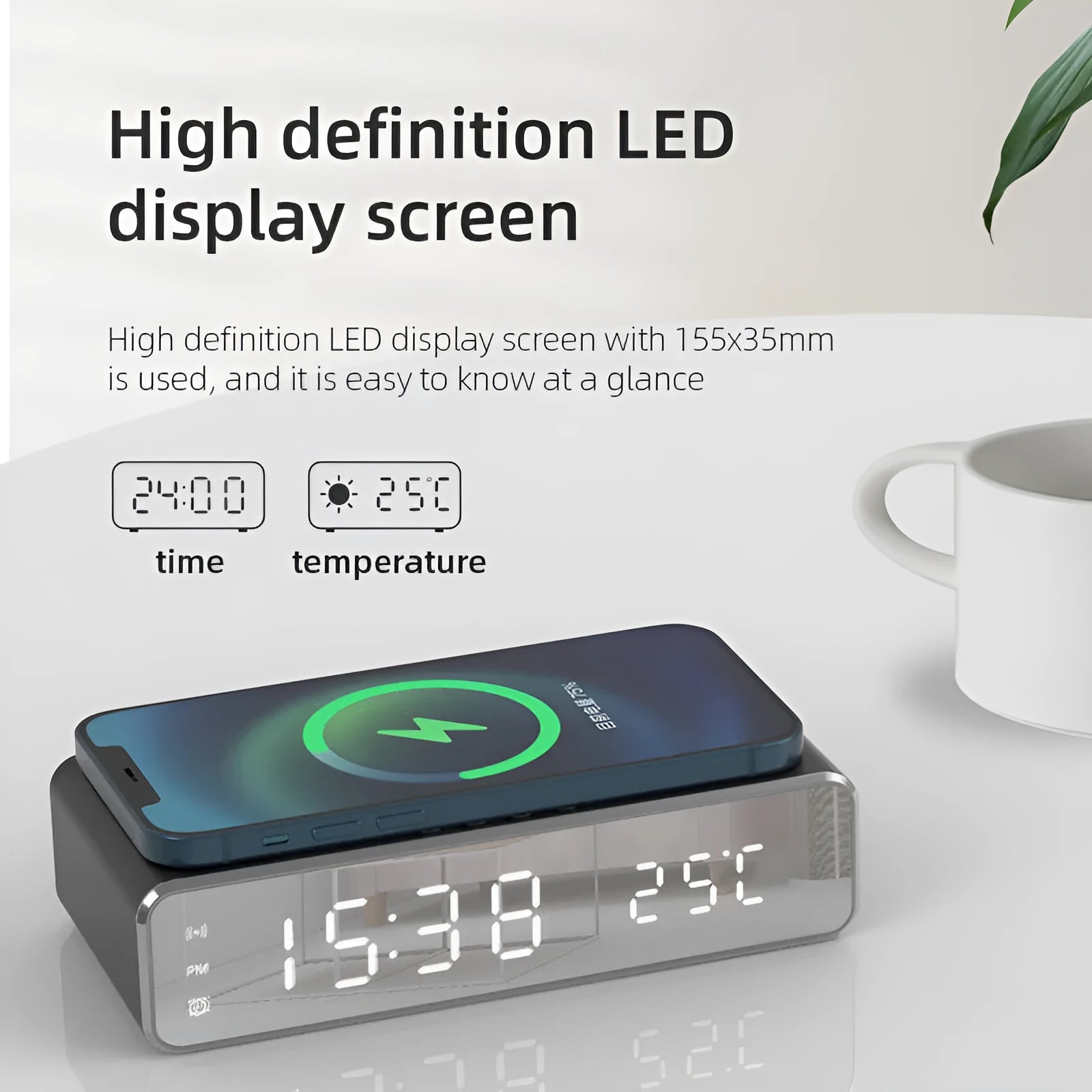 Silver wireless phone charger with clock display, thermometer reading, and integrated mirror on a desk