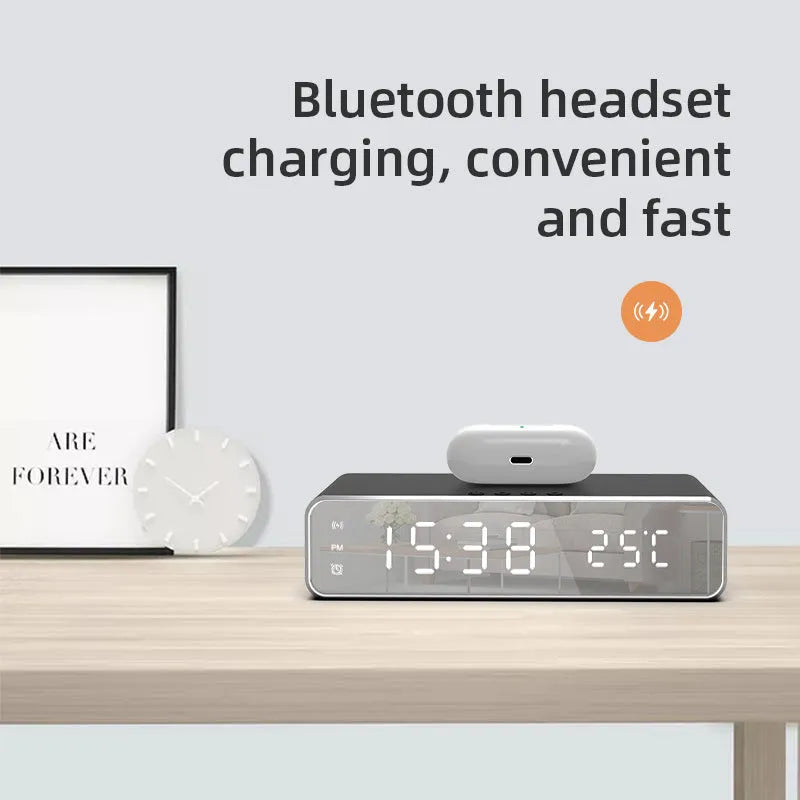 Silver wireless phone charger with clock display, thermometer reading, and integrated mirror on a desk