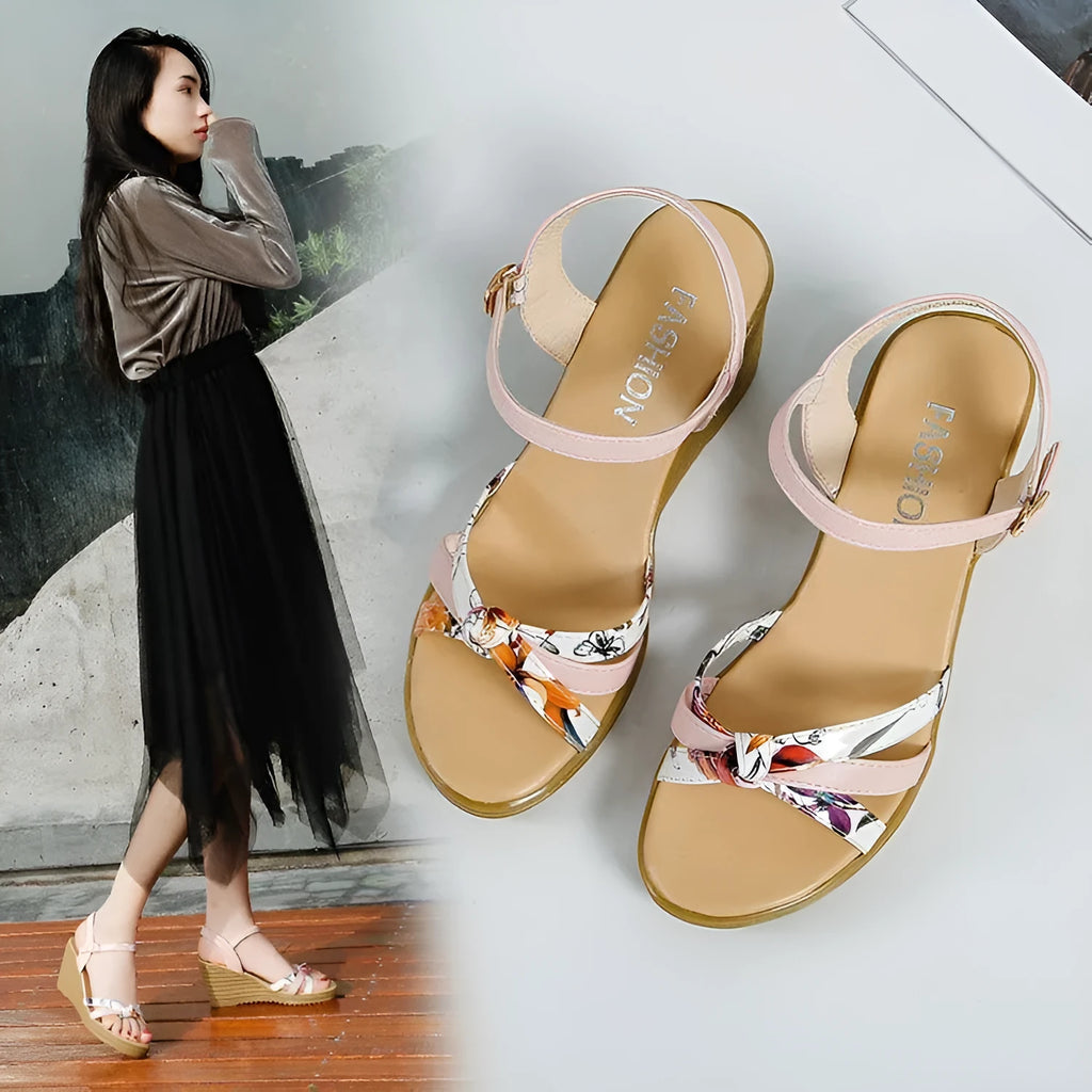 Pink women's wedge sandals with fish mouth open toe and buckle strap on a non-slip sole.