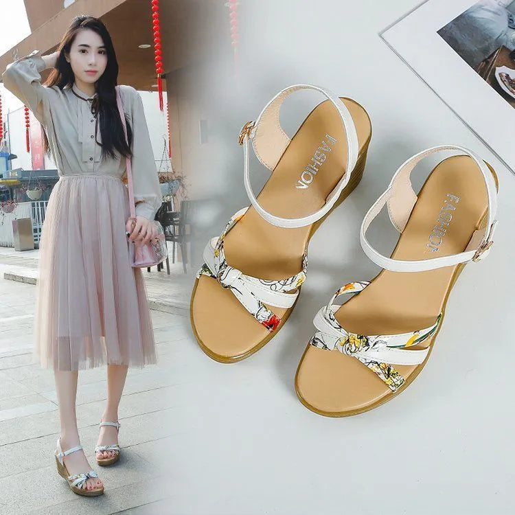 Pink women's wedge sandals with fish mouth open toe and buckle strap on a non-slip sole.