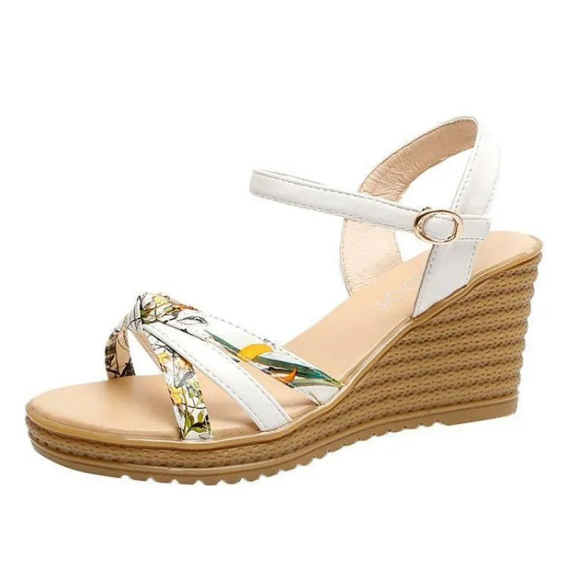 Pink women's wedge sandals with fish mouth open toe and buckle strap on a non-slip sole.
