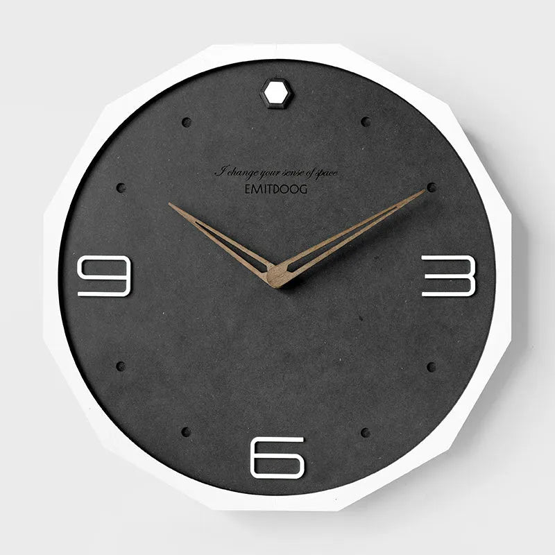 Round minimalist Nordic style wall clock with 12 inch diameter on a light-coloured wall.