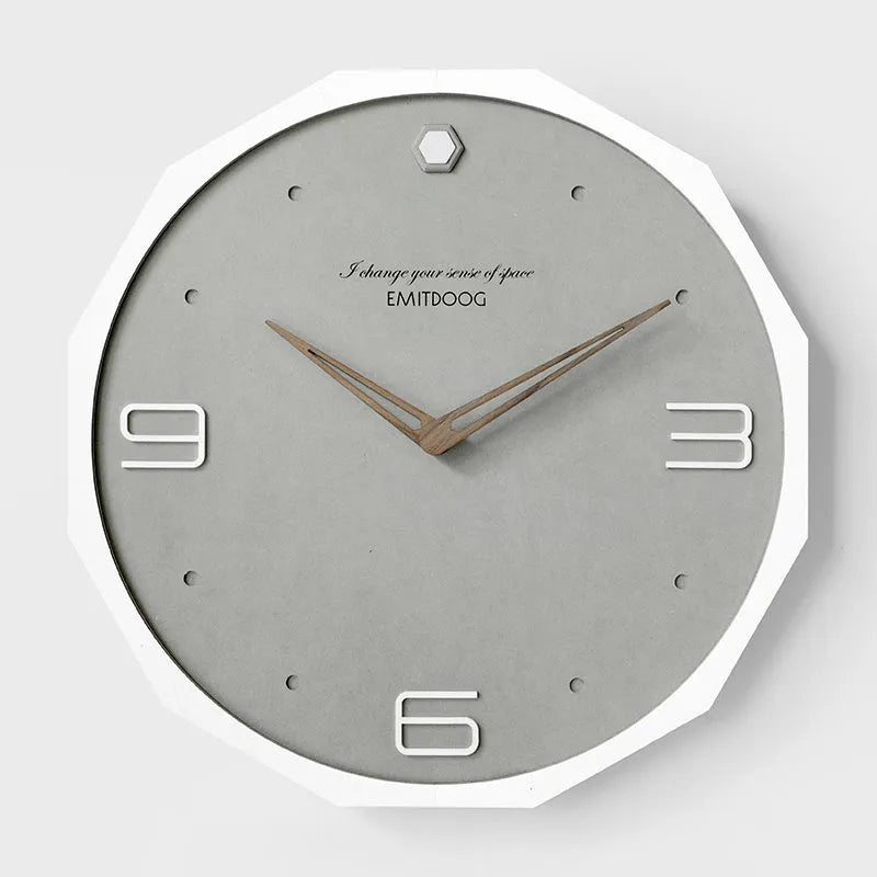 Round minimalist Nordic style wall clock with 12 inch diameter on a light-coloured wall.