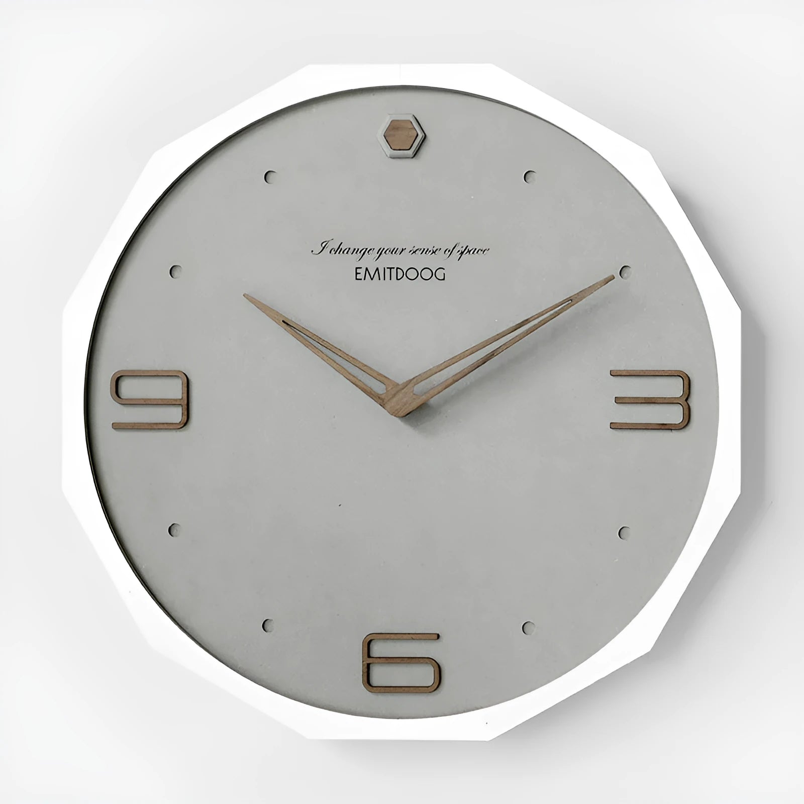 Round minimalist Nordic style wall clock with 12 inch diameter on a light-coloured wall.
