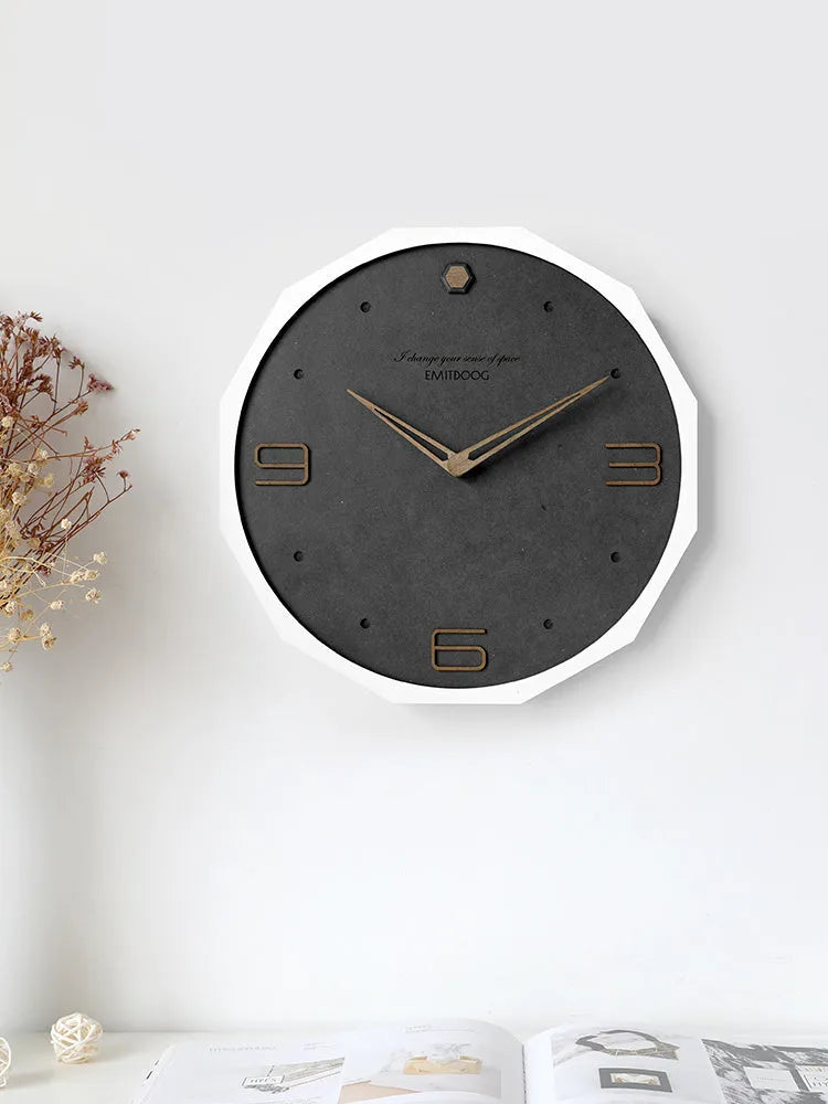 Round minimalist Nordic style wall clock with 12 inch diameter on a light-coloured wall.