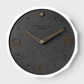 Round minimalist Nordic style wall clock with 12 inch diameter on a light-coloured wall.