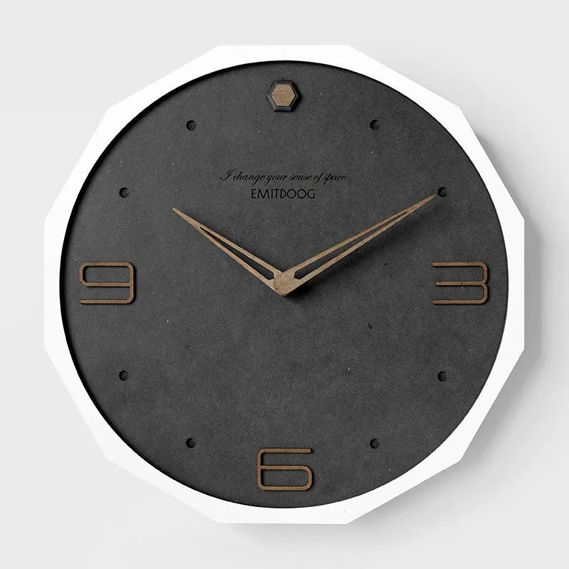 Round minimalist Nordic style wall clock with 12 inch diameter on a light-coloured wall.