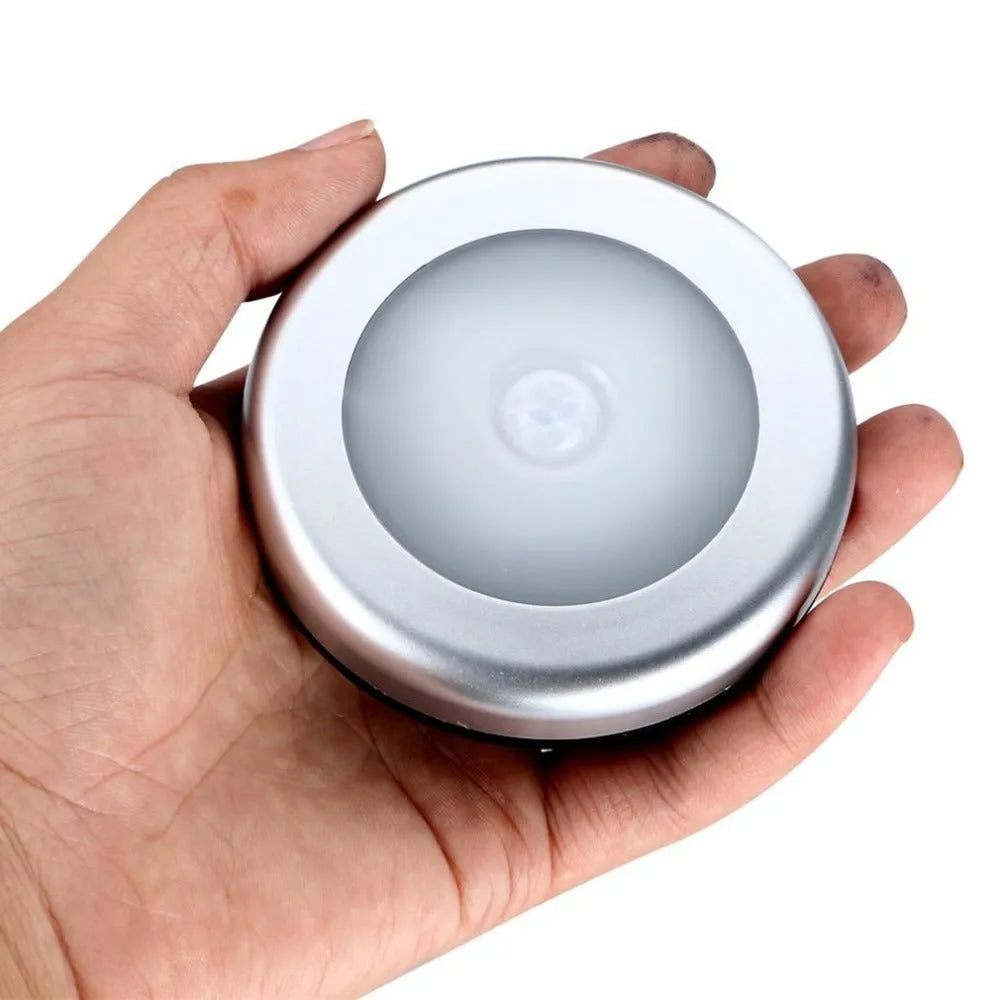 Silver battery-powered wireless motion sensor night light with a square PC plastic lampshade.