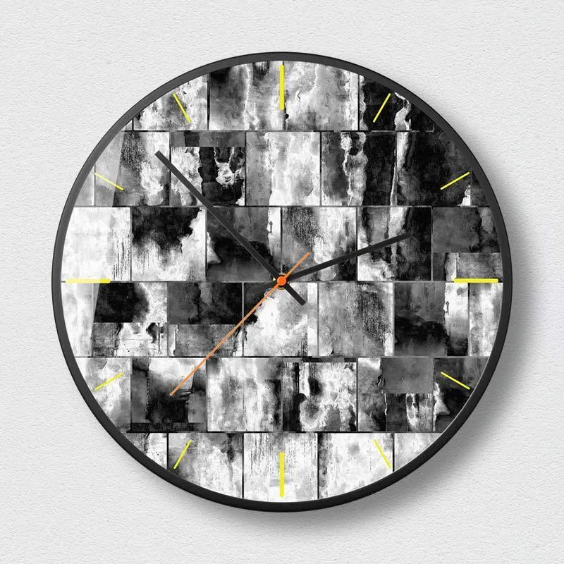 Round abstract art wall clock with metal frame in mysterious black, shown in 12 inch and 14 inch sizes.