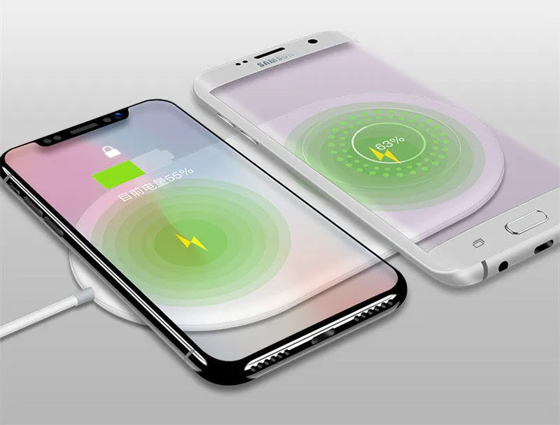 White dual wireless phone charger charging two mobile phones simultaneously