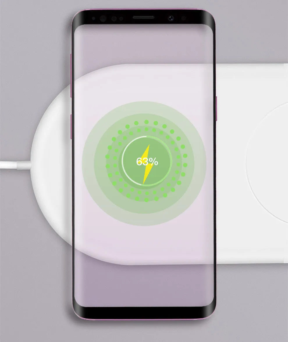 White dual wireless phone charger charging two mobile phones simultaneously