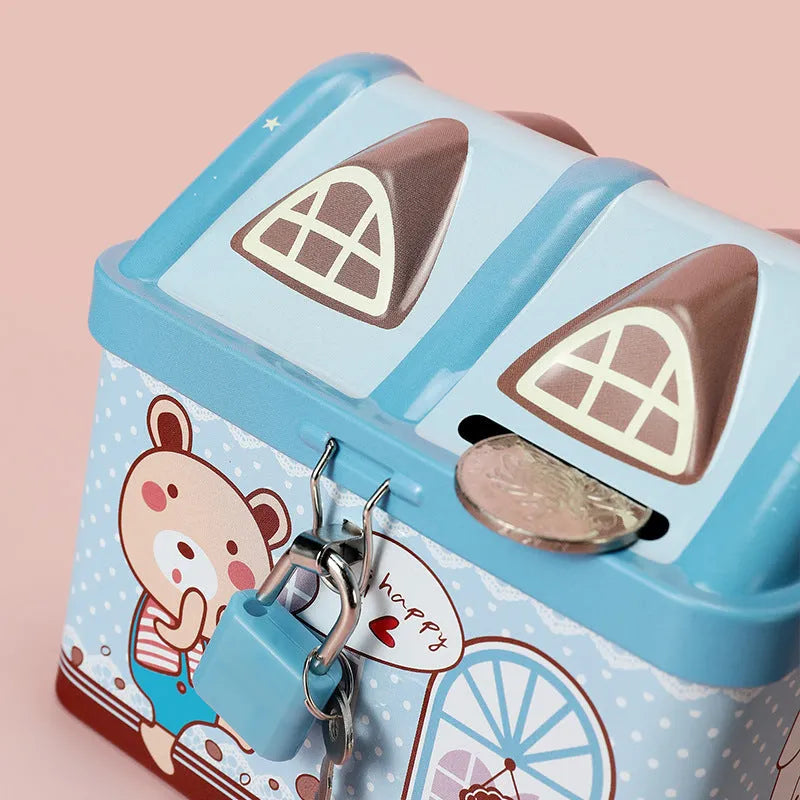 Blue house-shaped tinplate piggy bank on desktop with coin slot visible