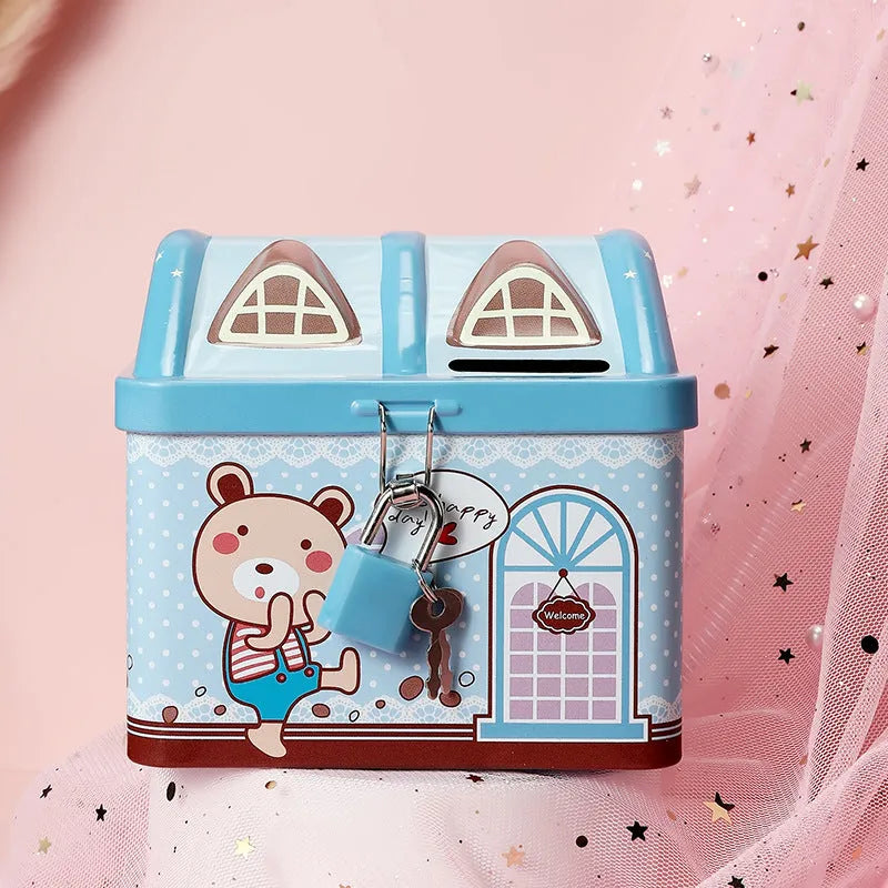 Blue house-shaped tinplate piggy bank on desktop with coin slot visible
