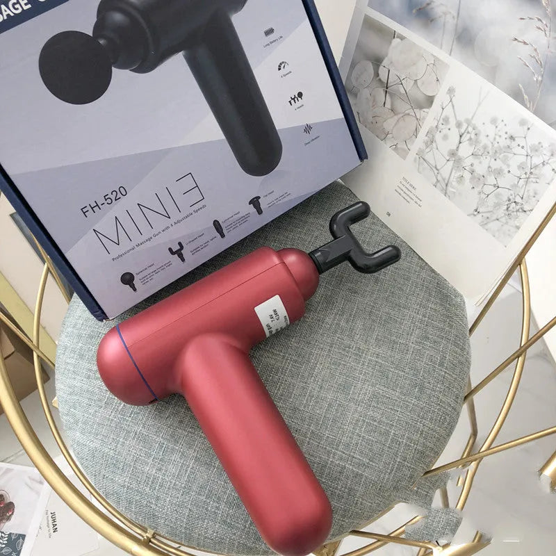 Grey handheld fascia gun massager with USB charging port for muscle relaxation therapy