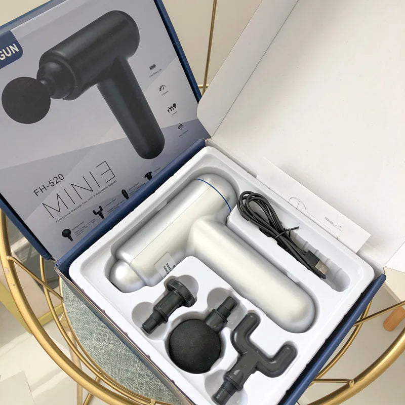 Grey handheld fascia gun massager with USB charging port for muscle relaxation therapy