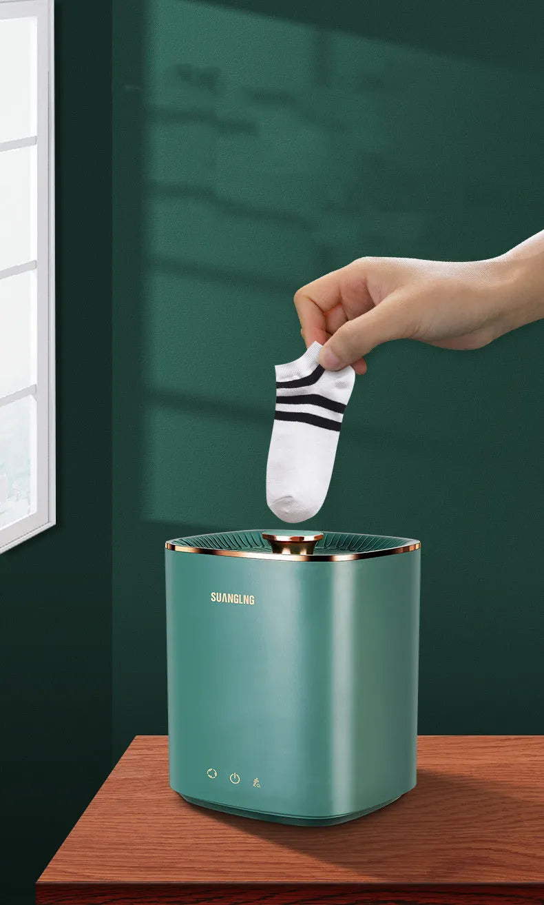 Green or white mini portable washing machine for underwear and socks on a countertop.