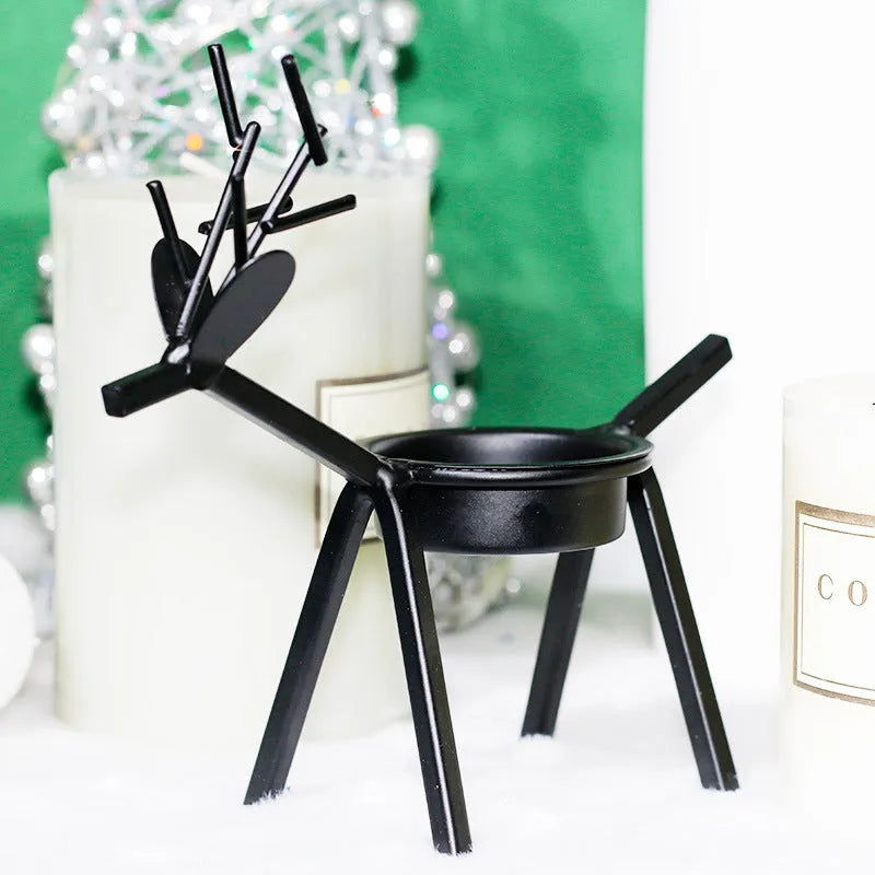 Black iron deer-shaped candlestick holder with fabric decorative elements for Christmas table decoration.