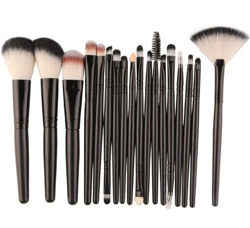 MAANGE 18-piece makeup brush set with fan-shaped cosmetic tools laid out on a table.