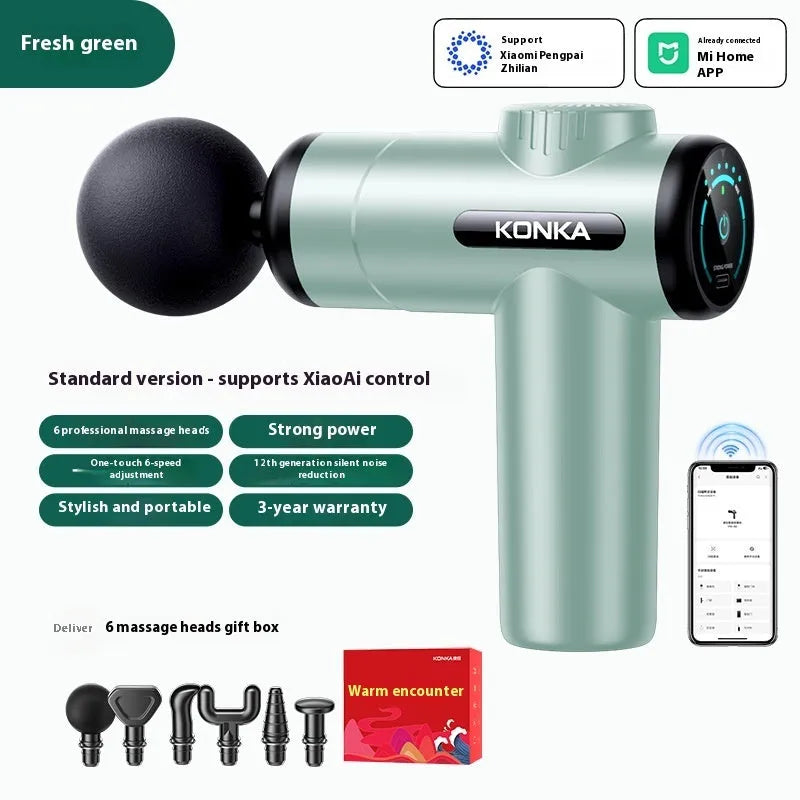 Konka V19 grey mini electric massage gun with multiple attachment heads on a table
