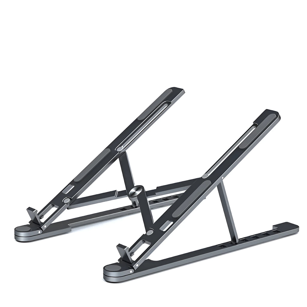 Deep grey portable aluminium laptop stand, folded flat next to an open laptop showing its adjustable height.