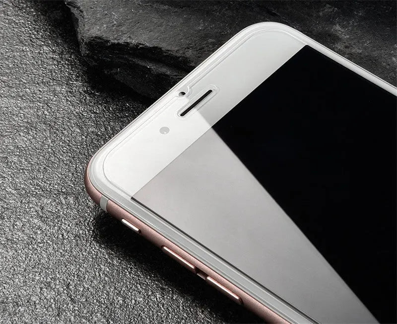 Tempered glass screen protector with 9H hardness for smartphones on a clean surface.