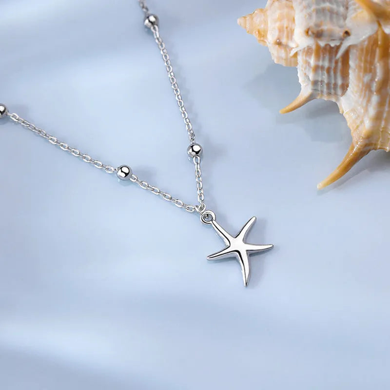 Sterling silver anklet with round beads and a starfish charm.