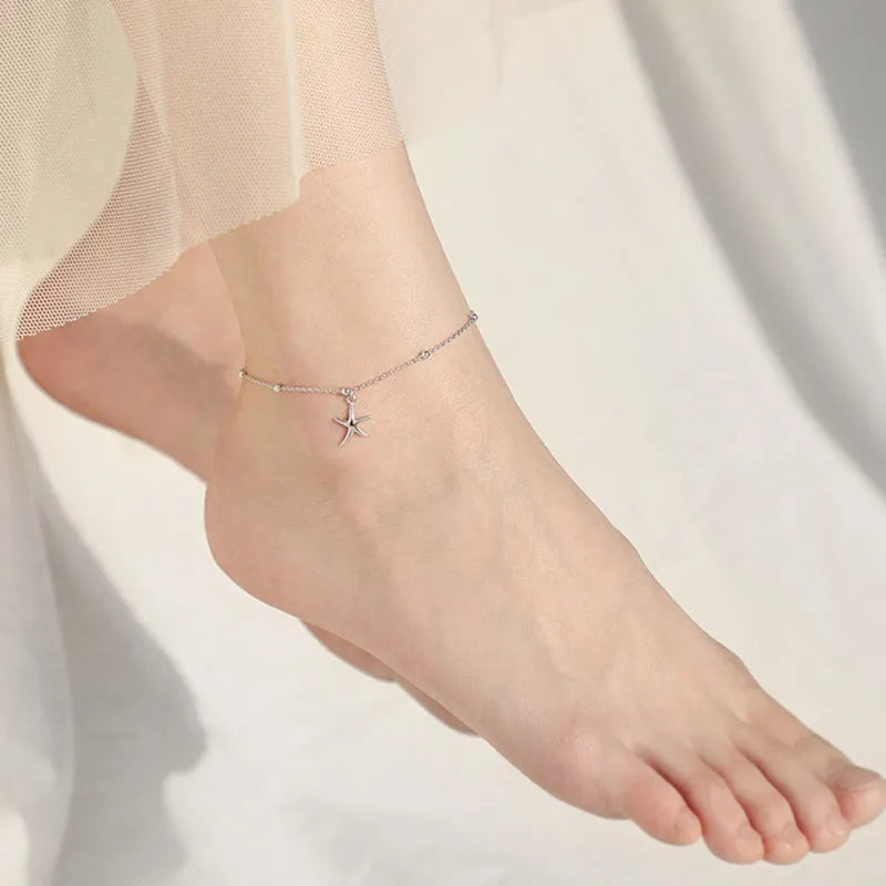 Sterling silver anklet with round beads and a starfish charm.