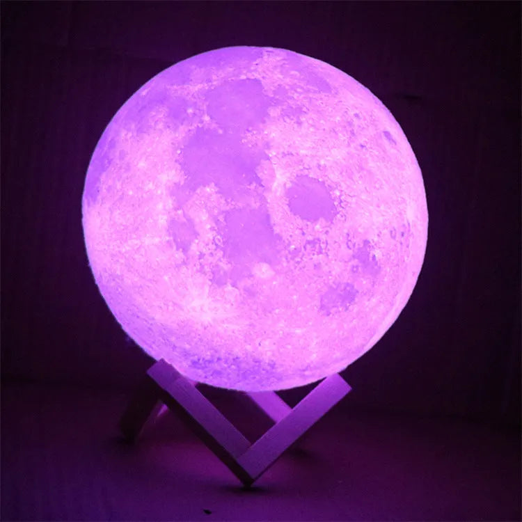 3D printed spherical moon lamp with textured surface on a wooden stand, showing white LED light.